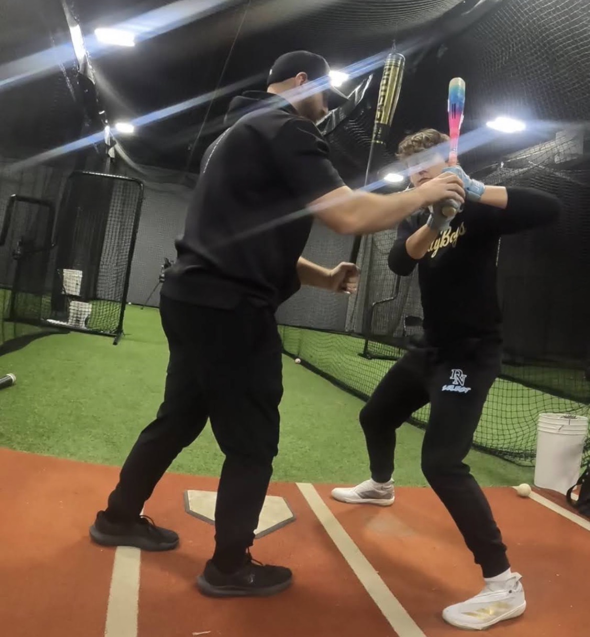 Hands-on swing correction in the cage